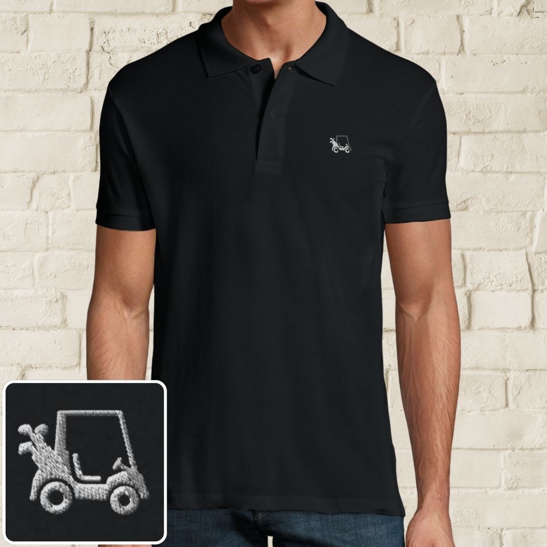 Golf Cart Polo in Black on a light wooden floor lying next to headphones and golf shoes.