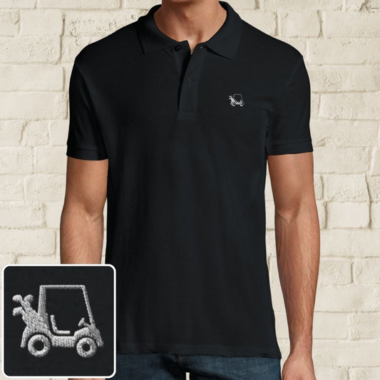 Golf Cart Polo in Black on a light wooden floor lying next to headphones and golf shoes.