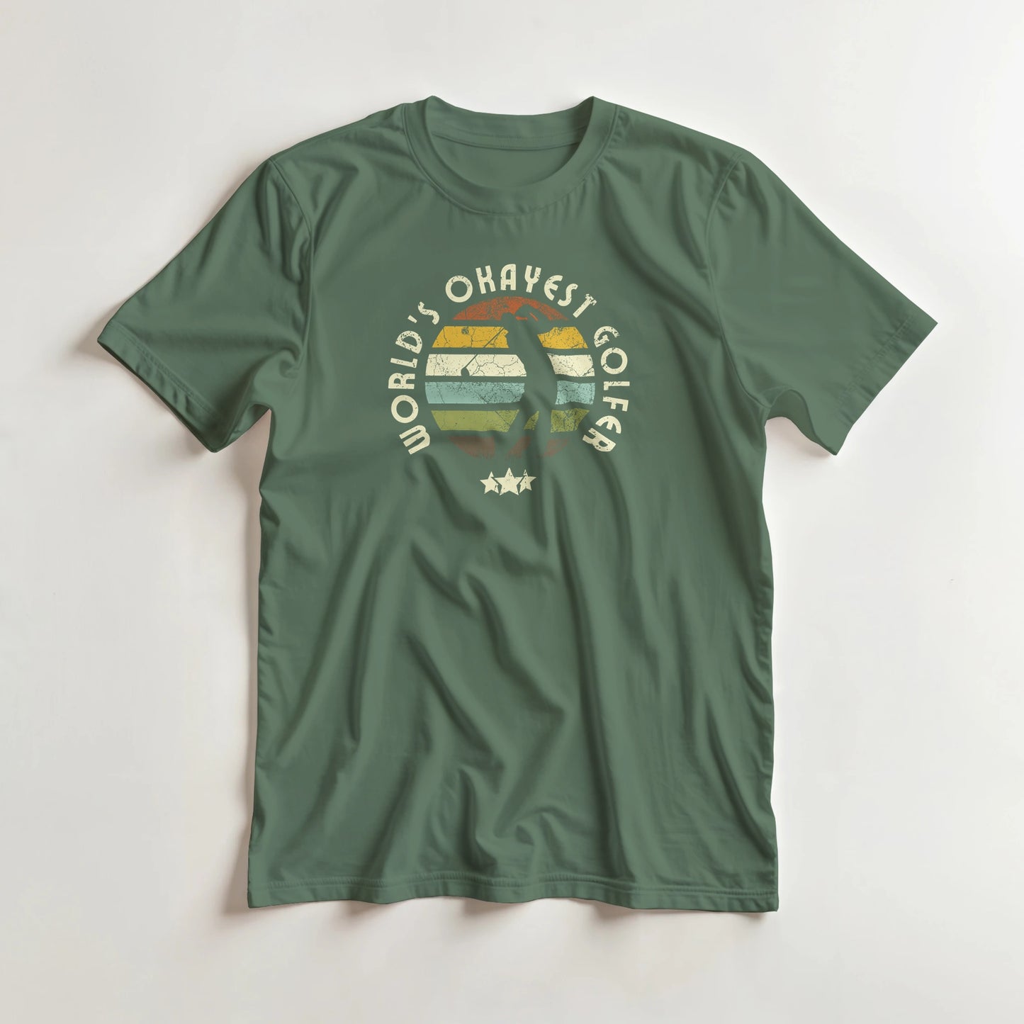 Okayest Golfer T-Shirt in Military Green lying on a plain floor. T-shirt is a unisex cut and 100 per cent cotton.