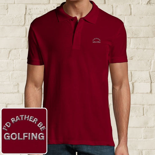 Rather Golfing Polo in Maroon on a light wooden floor lying next to headphones and golf shoes.