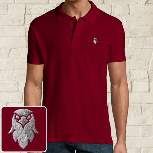 Eagle Polo in Maroon on a light wooden floor lying next to headphones and golf shoes.