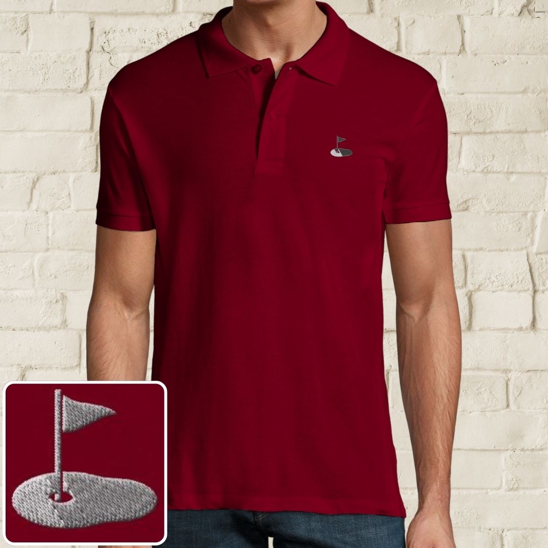 Flag Polo in Maroon on a light wooden floor lying next to headphones and golf shoes.