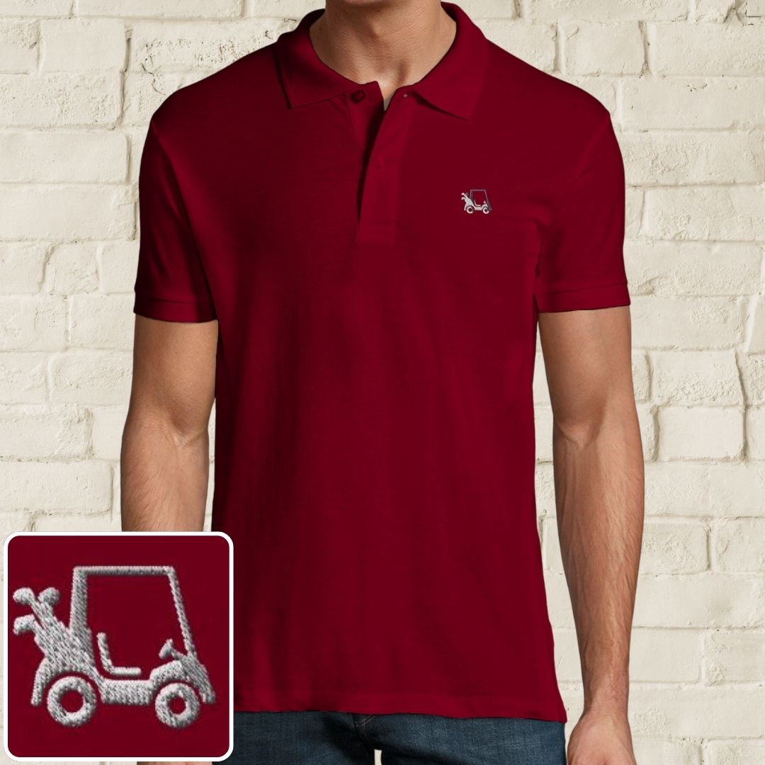 Golf Cart Polo in Maroon on a light wooden floor lying next to headphones and golf shoes.