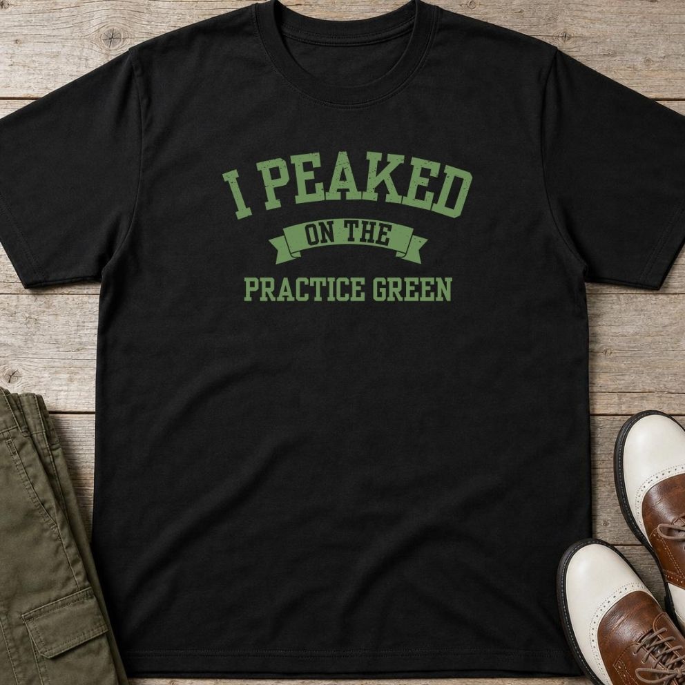 Practice Green T-Shirt in Black lying on a plain floor. T-shirt is a unisex cut and 100 per cent cotton.