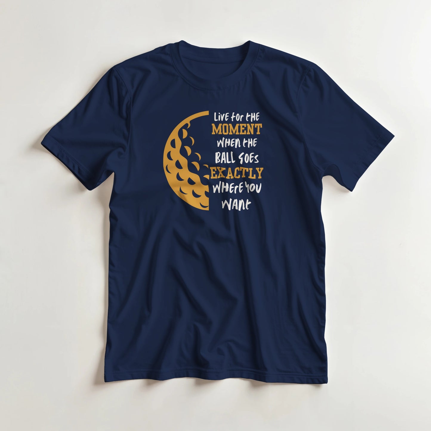 The Moment T-Shirt in Navy lying on a plain floor. T-shirt is a unisex cut and 100 per cent cotton.