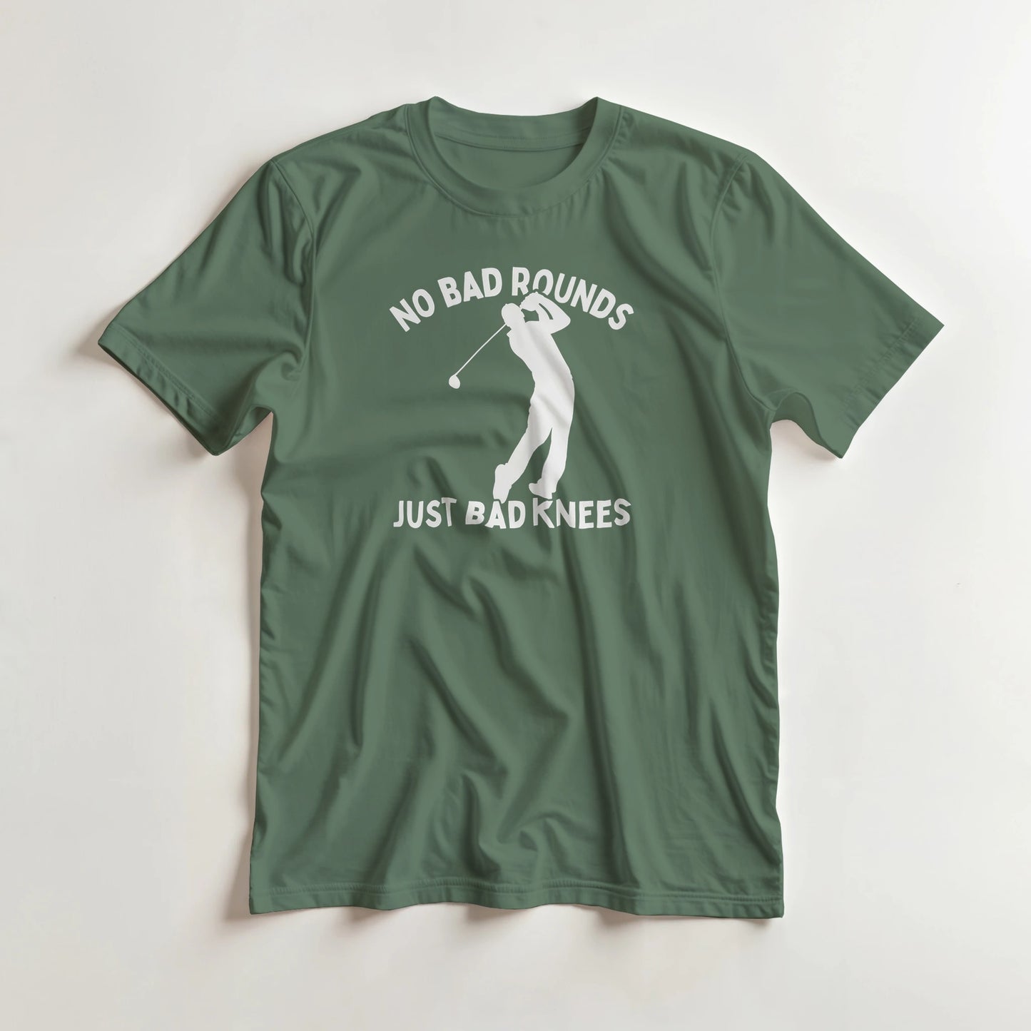 Bad Knees T-Shirt in Military Green lying on a plain floor. T-shirt is a unisex cut and 100 per cent cotton.