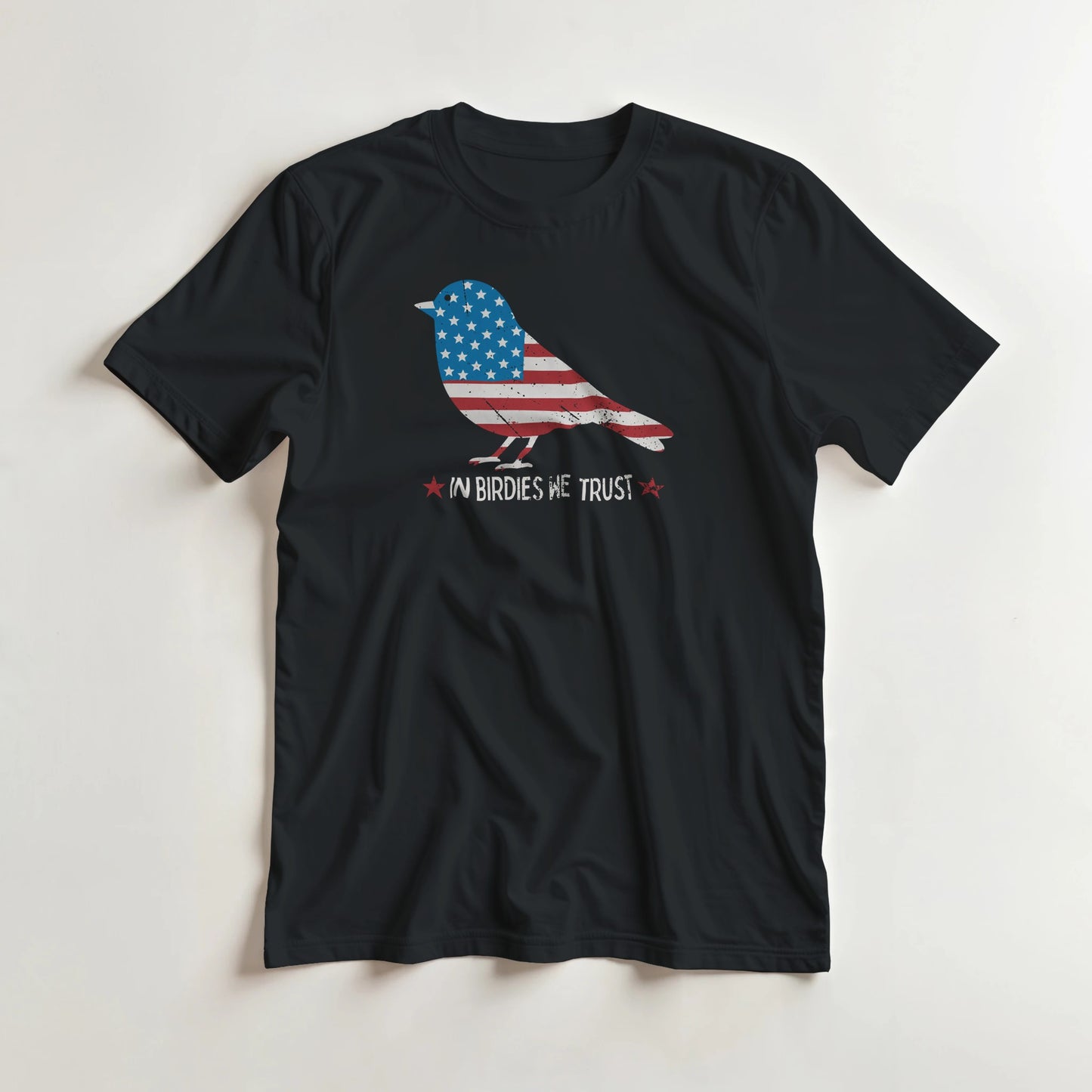 In Birdies We Trust T-Shirt in Black lying on a plain floor. T-shirt is a unisex cut and 100 per cent cotton.