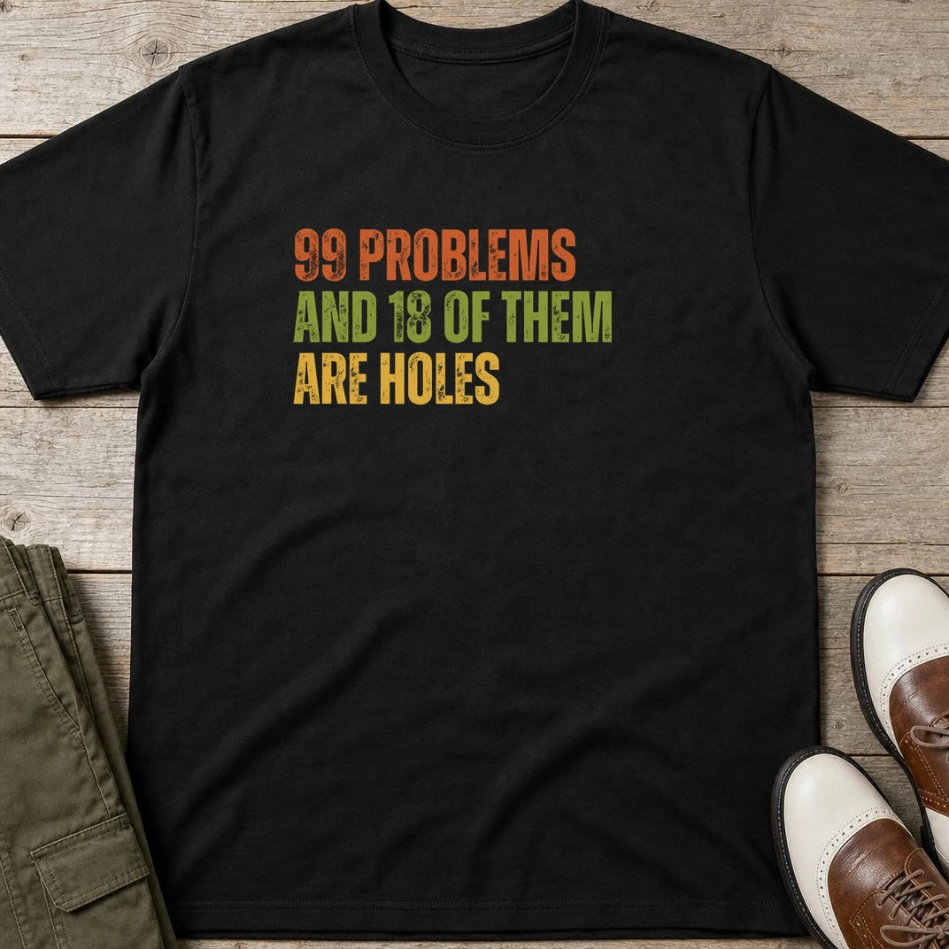 99 Problems T-Shirt in Black lying on a plain floor. T-shirt is a unisex cut and 100 per cent cotton.