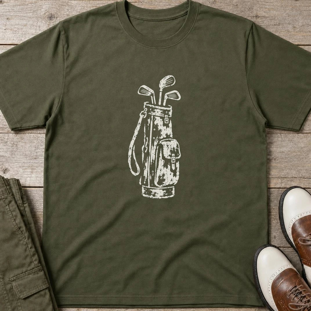 Vintage Golf Bag T-Shirt in Military Green lying on a plain floor. T-shirt is a unisex cut and 100 per cent cotton.