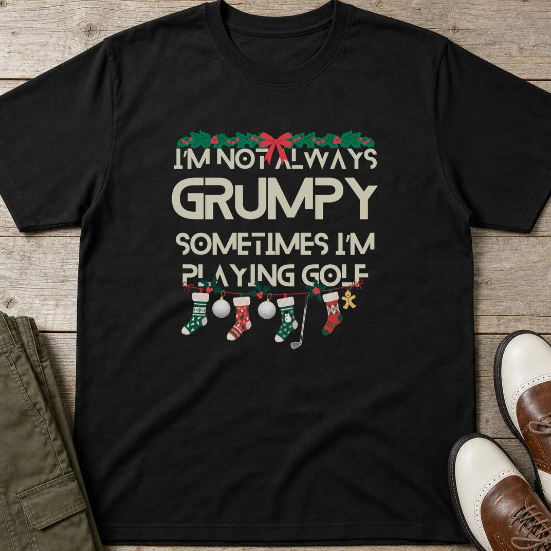 Grumpy Christmas T-Shirt in Black lying on a plain floor. T-shirt is a unisex cut and 100 per cent cotton.