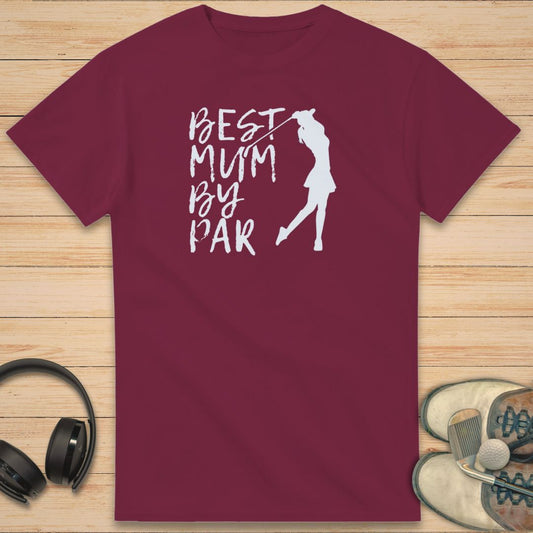 Best Mum T-Shirt in Maroon on a light wooden floor lying next to headphones and golf shoes.