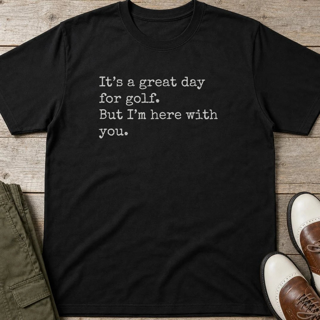 Here With You T-Shirt in Black lying on a plain floor. T-shirt is a unisex cut and 100 per cent cotton.