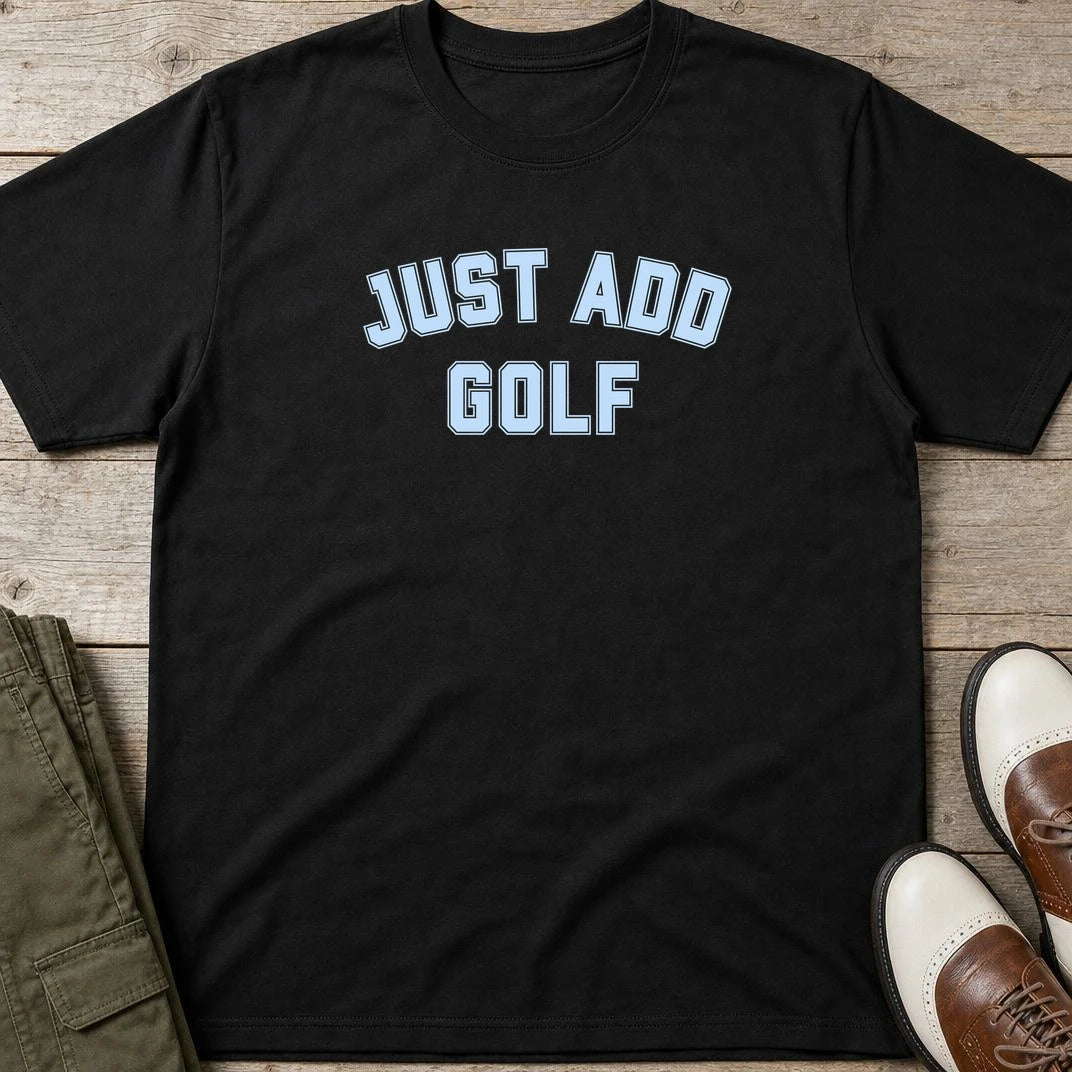 Just Add Golf T-Shirt in Black lying on a plain floor. T-shirt is a unisex cut and 100 per cent cotton.