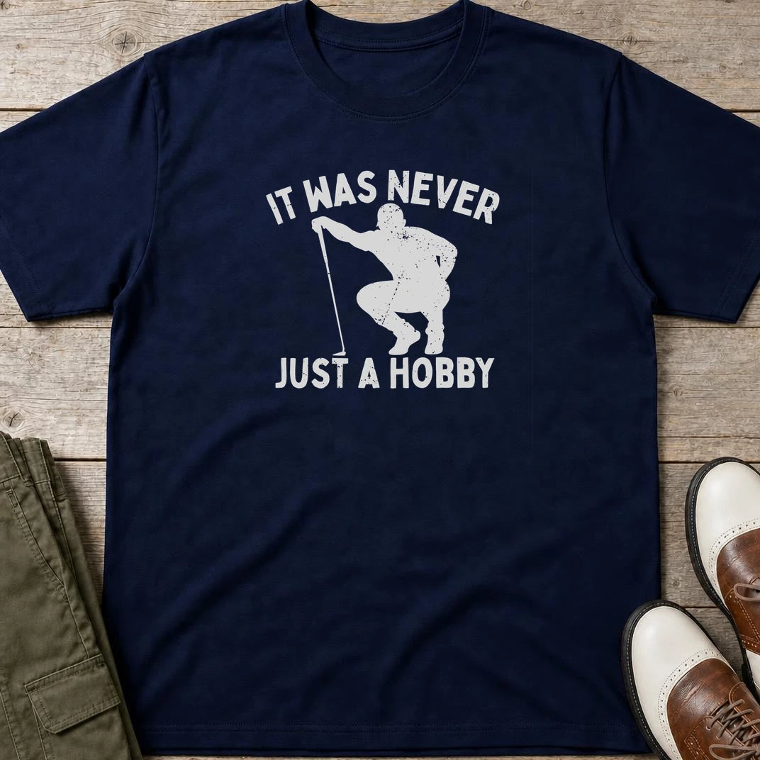 Just A Hobby T-Shirt in Navy lying on a plain floor. T-shirt is a unisex cut and 100 per cent cotton.