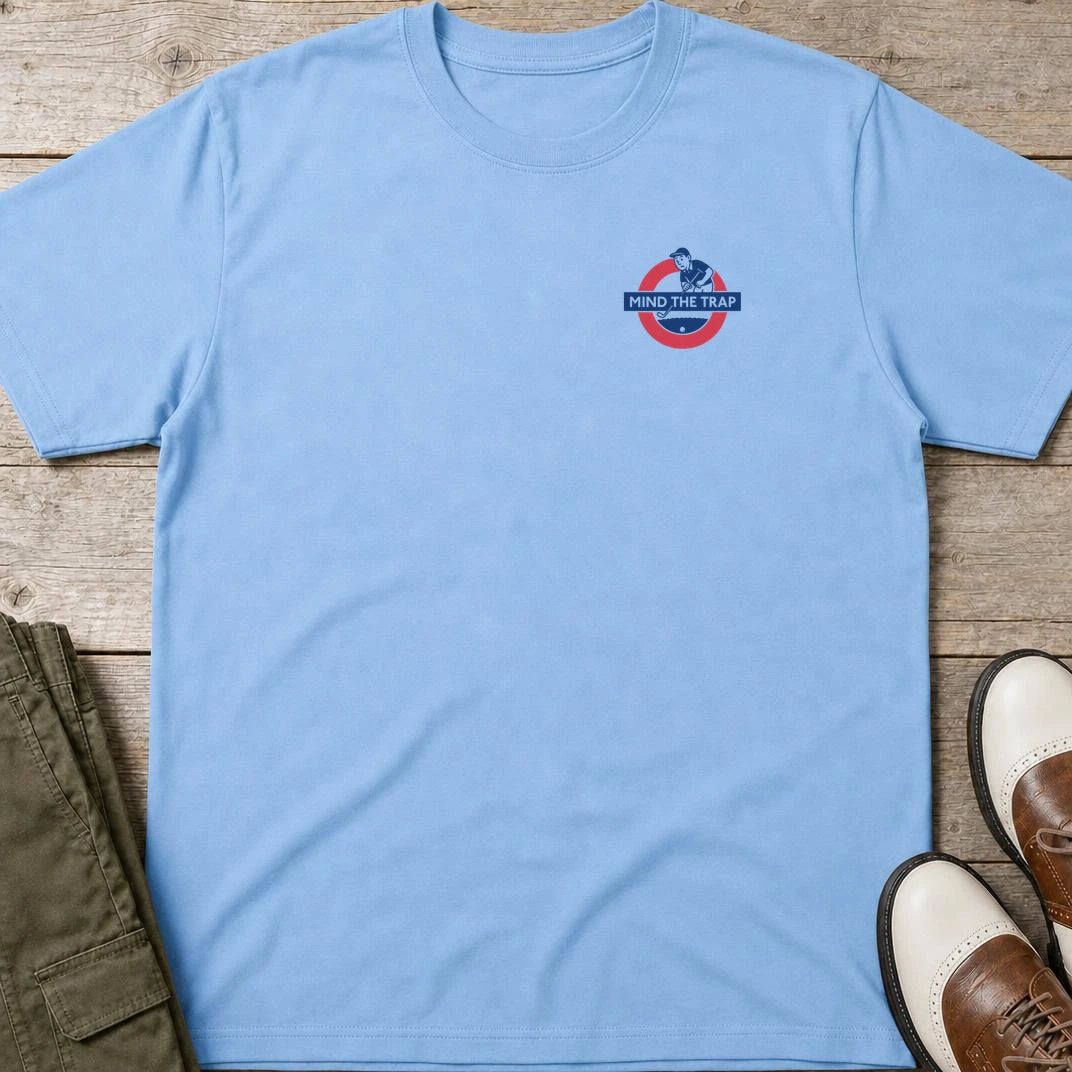 Mind Trap Pocket T-Shirt in Light Blue lying on a plain floor. T-shirt is a unisex cut and 100 per cent cotton.