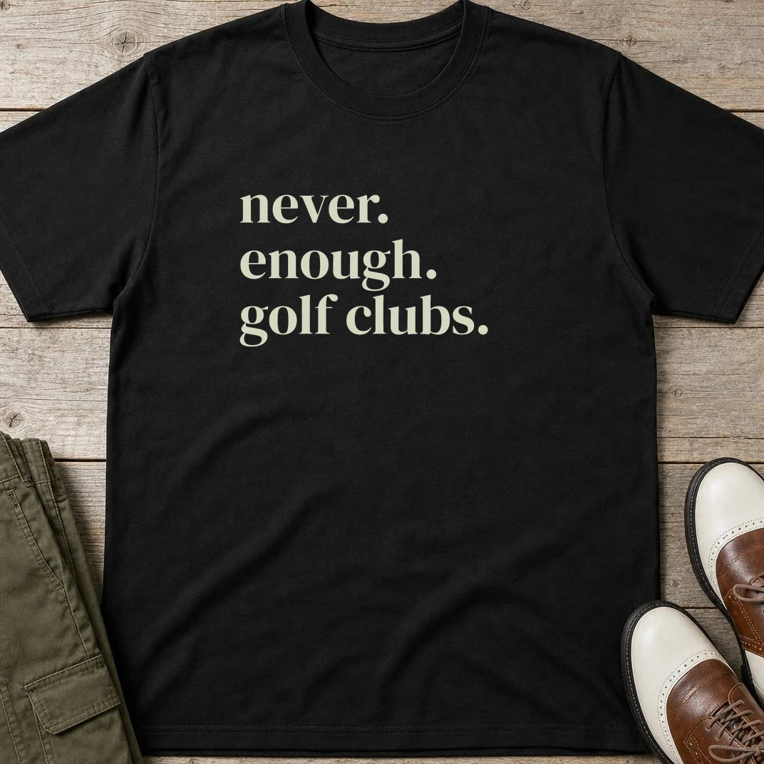 Never Enough T-Shirt in Black lying on a plain floor. T-shirt is a unisex cut and 100 per cent cotton.