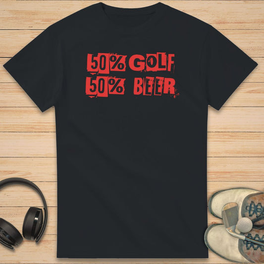 50% Golf T-Shirt in Black on a light wooden floor lying next to headphones and golf shoes.
