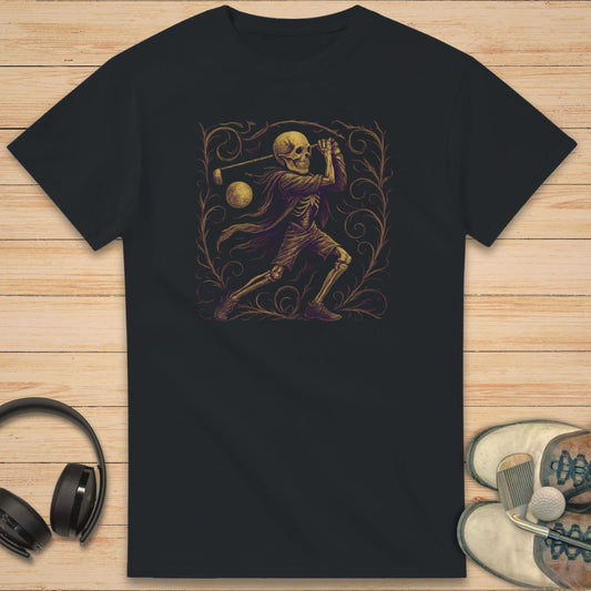 Skeleton Golfer T-Shirt in on a light wooden floor lying next to headphones and golf shoes.