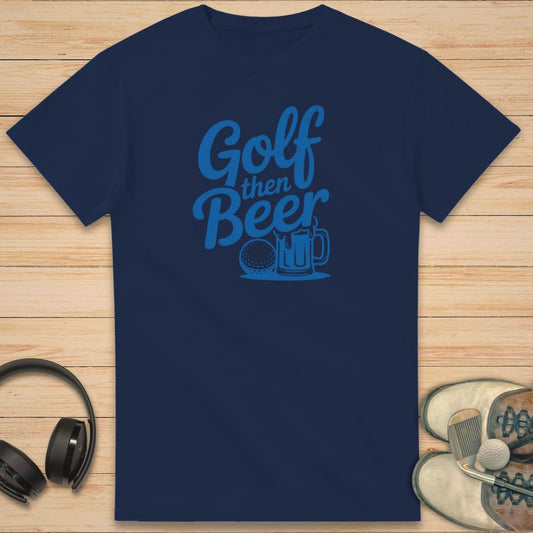 Golf Beer T-Shirt in Navy on a light wooden floor lying next to headphones and golf shoes.