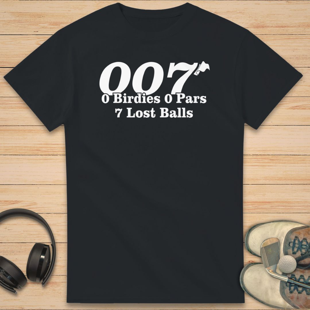 Black t-shirt with humorous golf text design on a wooden surface with headphones and shoes.