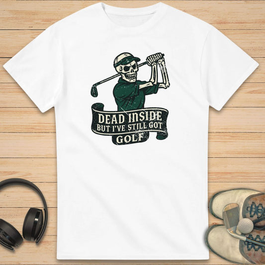 Dead Inside T-Shirt in White on a light wooden floor lying next to headphones and golf shoes.