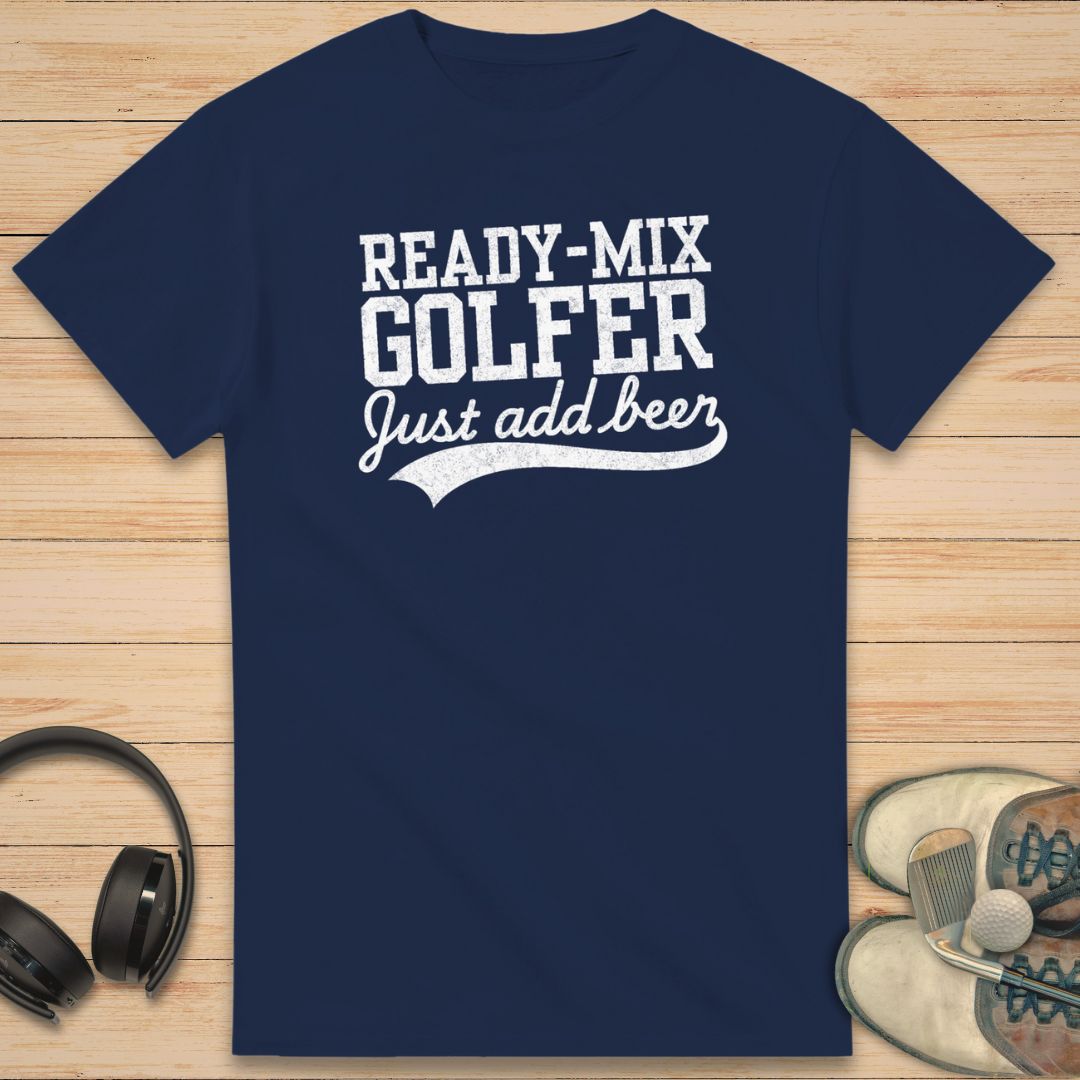 Ready-Mix T-Shirt in Navy on a light wooden floor lying next to headphones and golf shoes.