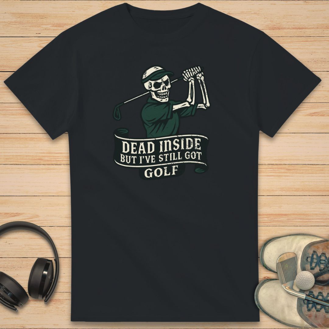Dead Inside T-Shirt in Black on a light wooden floor lying next to headphones and golf shoes.