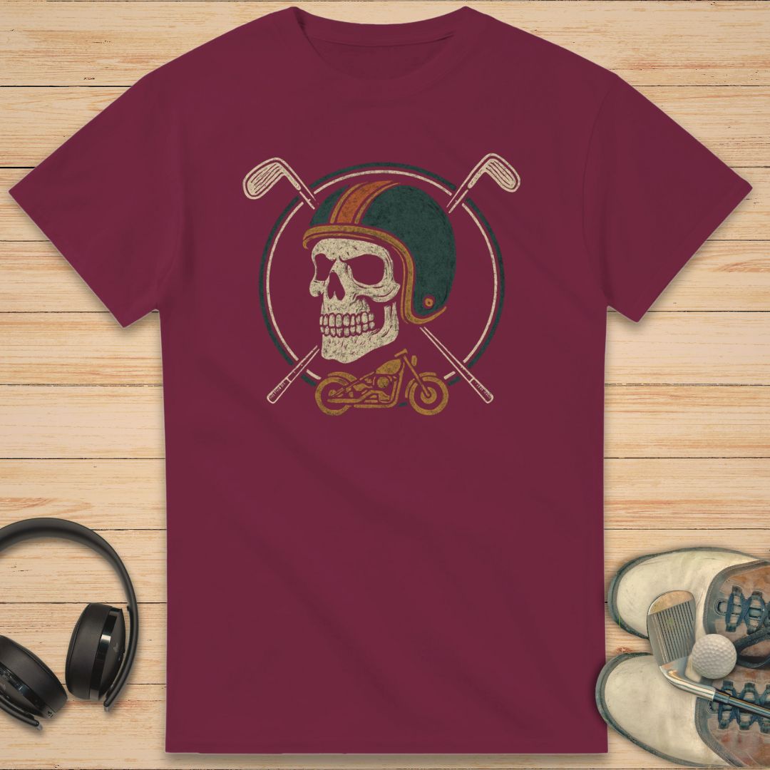 Golfing Biker T-Shirt in Maroon on a light wooden floor lying next to headphones and golf shoes.