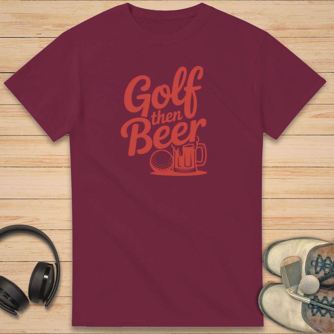 Golf Beer T-Shirt in Maroon on a light wooden floor lying next to headphones and golf shoes.