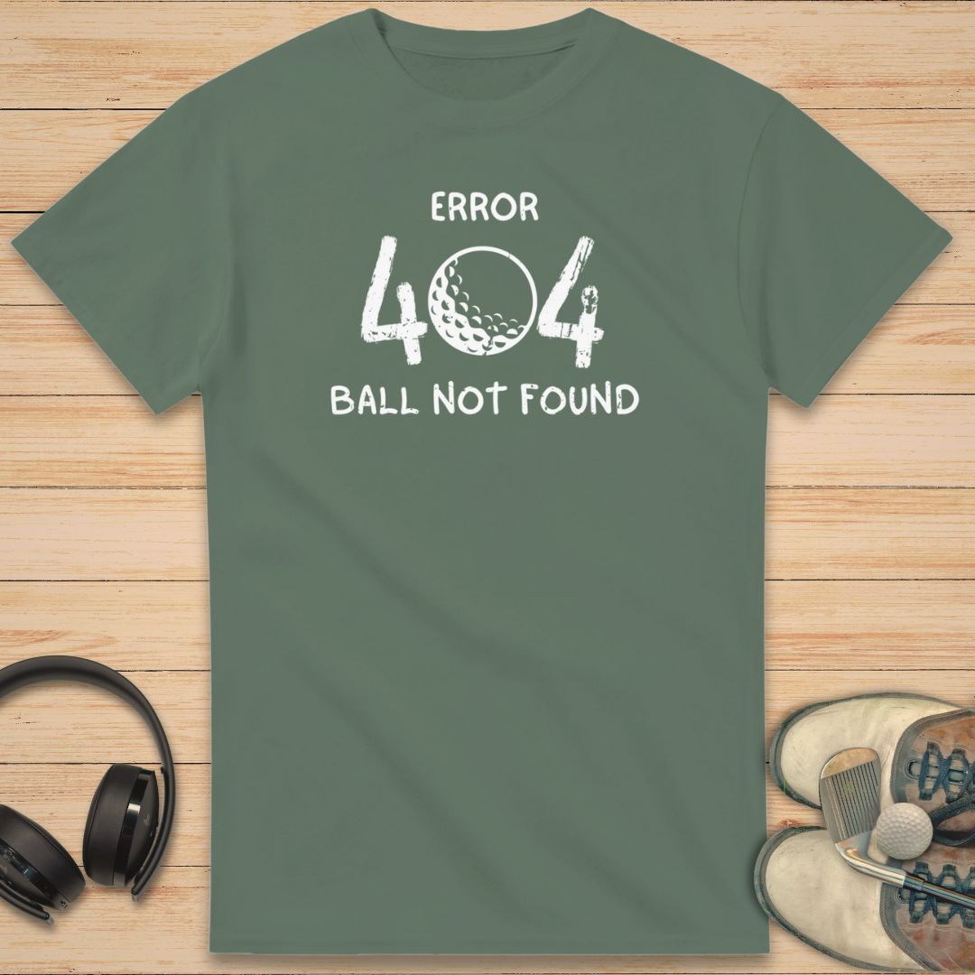 Error 404 T-Shirt in Military Green on a light wooden floor lying next to headphones and golf shoes.