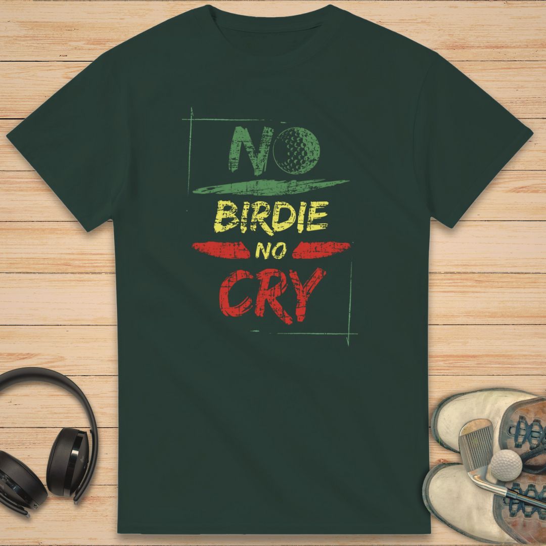 No Birdie No Cry T-Shirt in Forest Green on a light wooden floor lying next to headphones and golf shoes.
