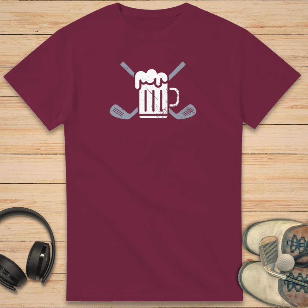 Beer Club T-Shirt in Maroon on a light wooden floor lying next to headphones and golf shoes.