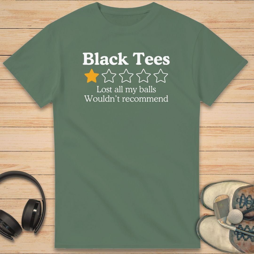Black Tees T-Shirt in Military Green on a light wooden floor lying next to headphones and golf shoes.