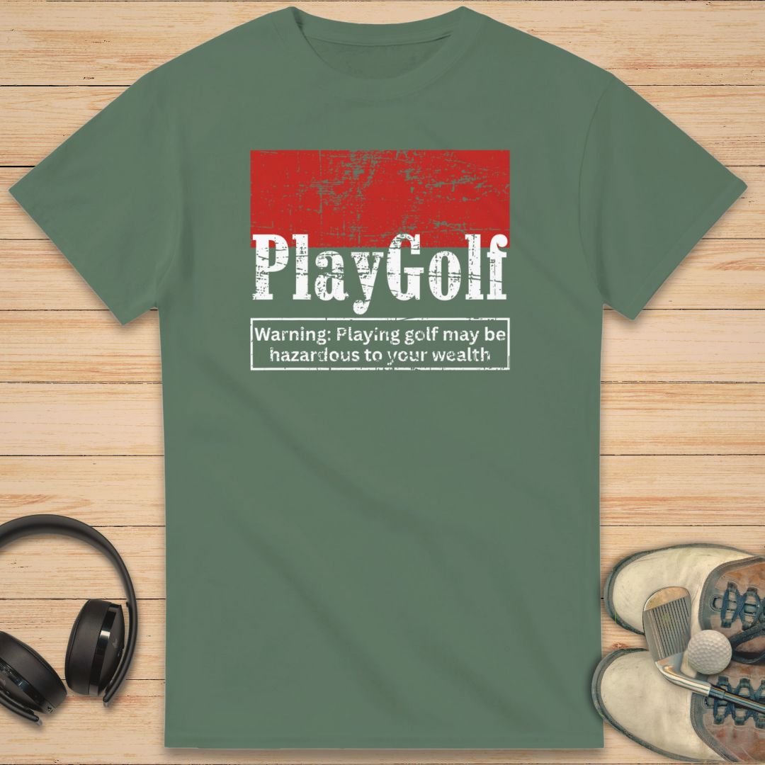 Play Golf T-Shirt in Military Green on a light wooden floor lying next to headphones and golf shoes.