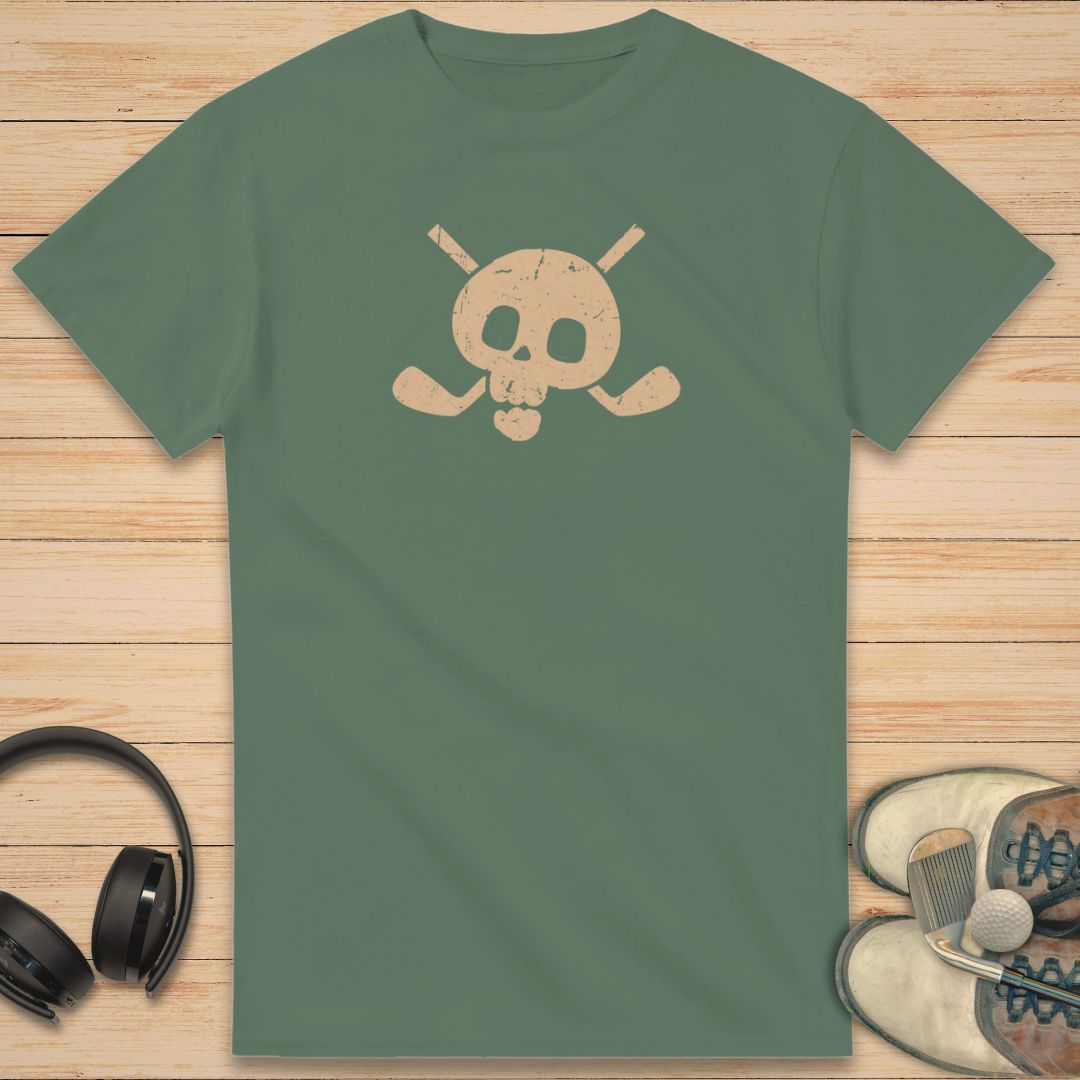 Skull X-Clubs T-Shirt in Military Green on a light wooden floor lying next to headphones and golf shoes.