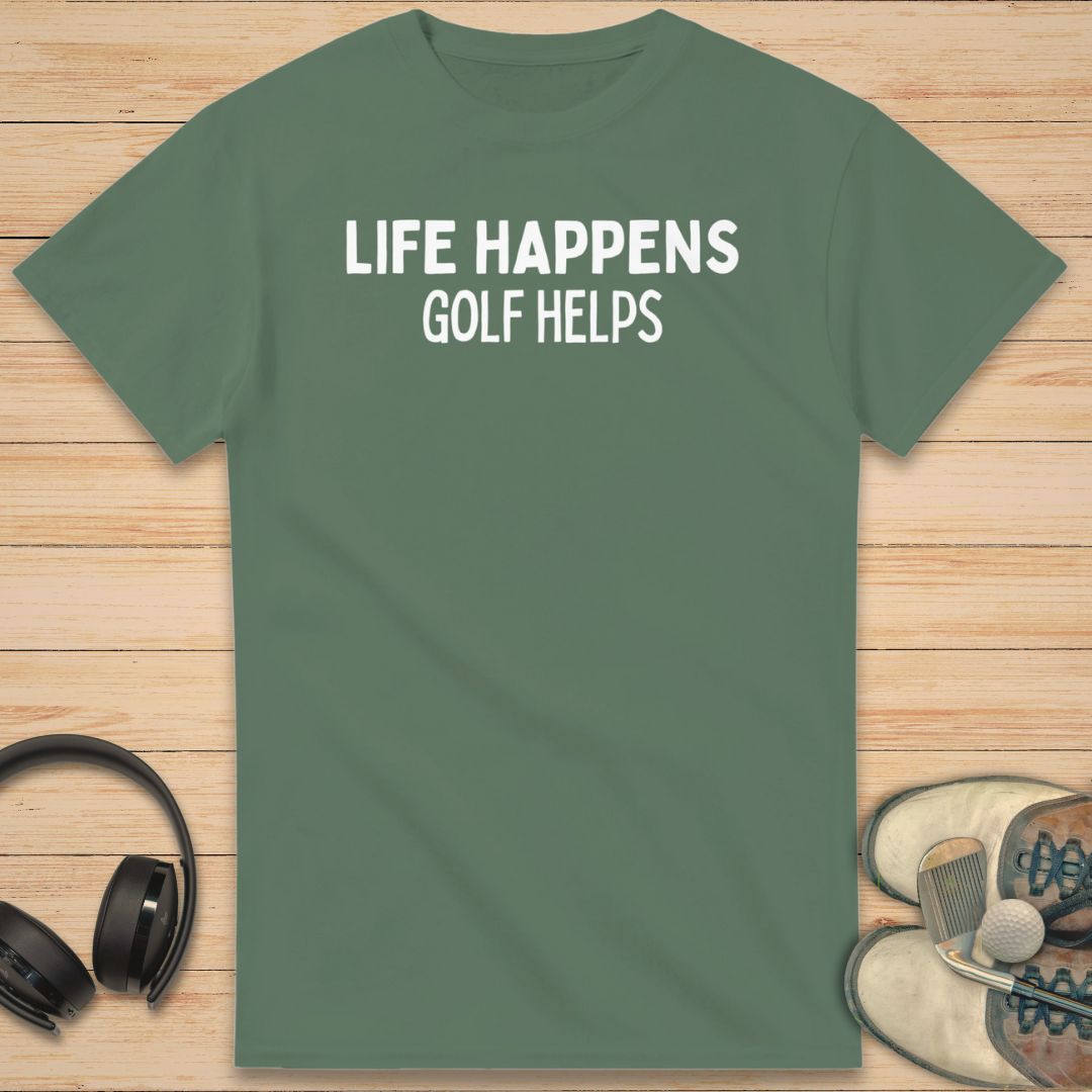 Golf Helps T-Shirt in Military Green on a light wooden floor lying next to headphones and golf shoes.