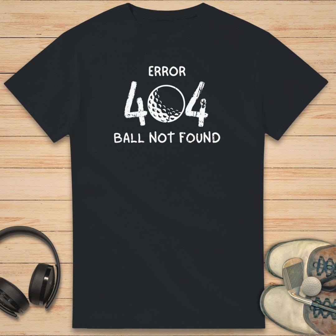 Error 404 T-Shirt in Black on a light wooden floor lying next to headphones and golf shoes.