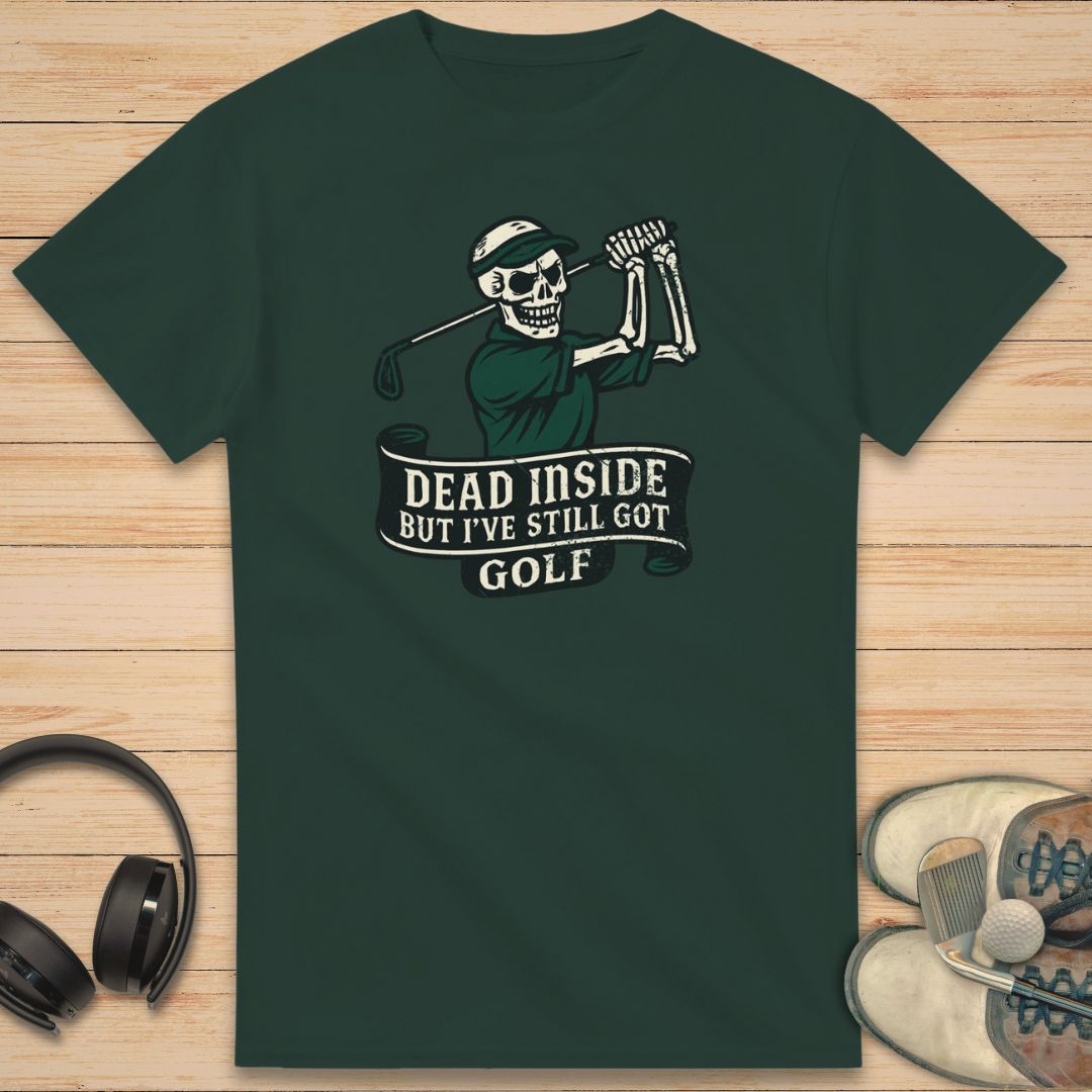 Dead Inside T-Shirt in Forest Green on a light wooden floor lying next to headphones and golf shoes.