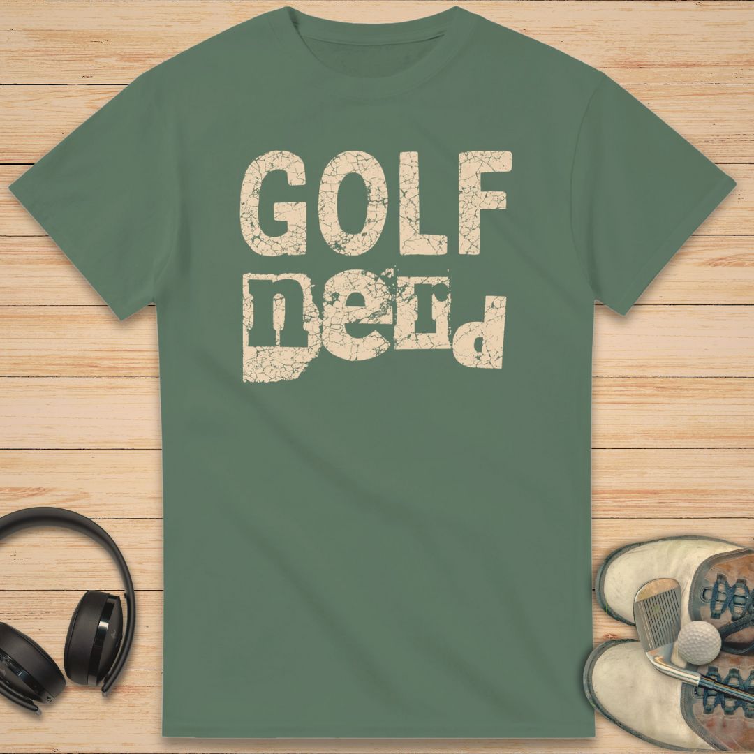 Golf Nerd T-Shirt in Military Green on a light wooden floor lying next to headphones and golf shoes.