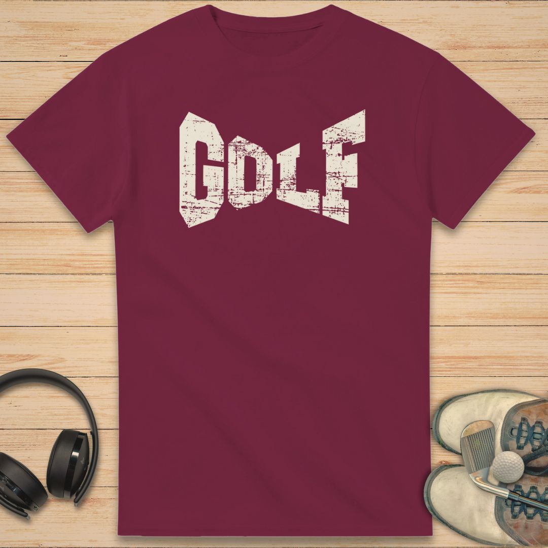 Maroon t-shirt with 'GOLF' text on a wooden surface with headphones and sneakers.