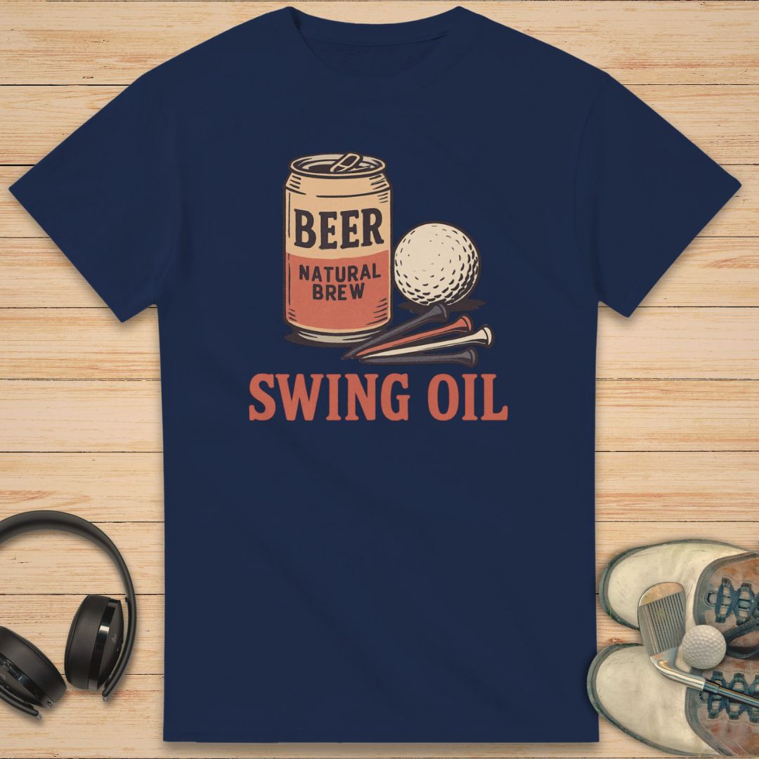 Swing Oil T-Shirt in Navy on a light wooden floor lying next to headphones and golf shoes.