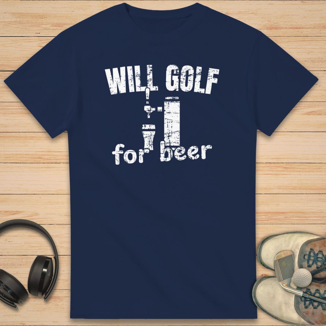 For Beer T-Shirt in Navy on a light wooden floor lying next to headphones and golf shoes.
