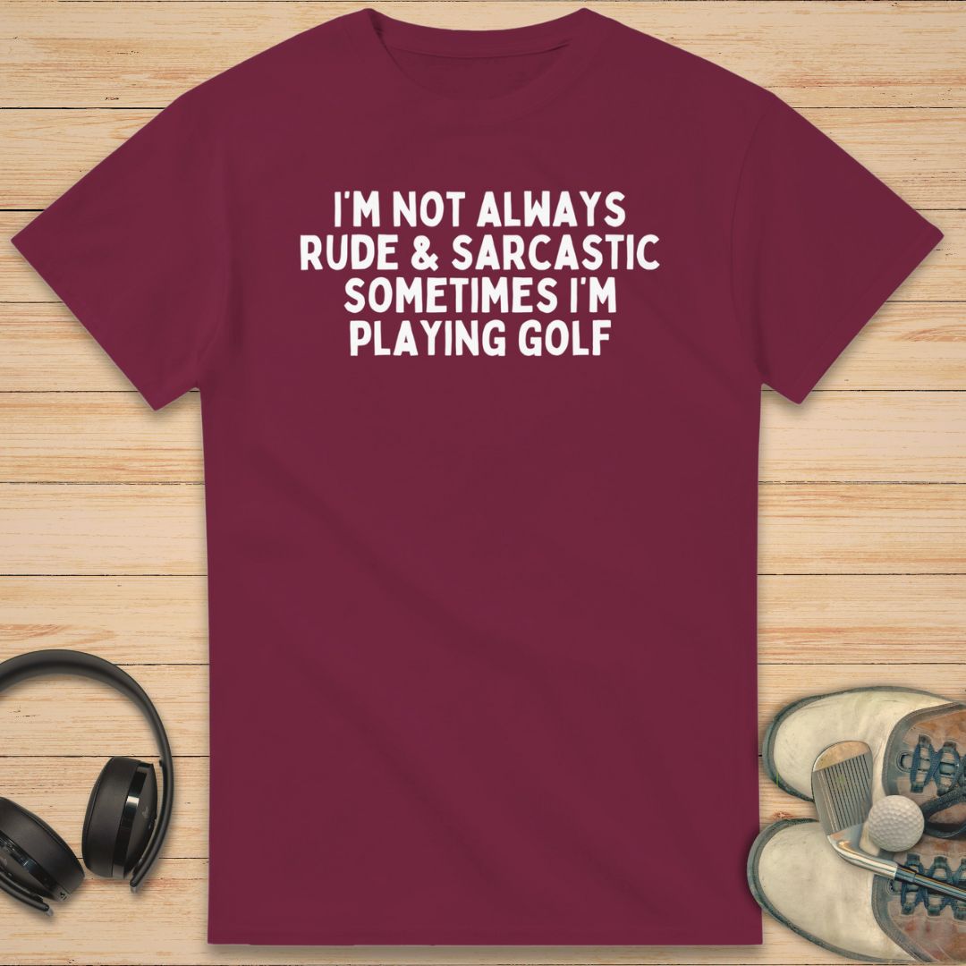 Sarcastic T-Shirt in Maroon on a light wooden floor lying next to headphones and golf shoes.