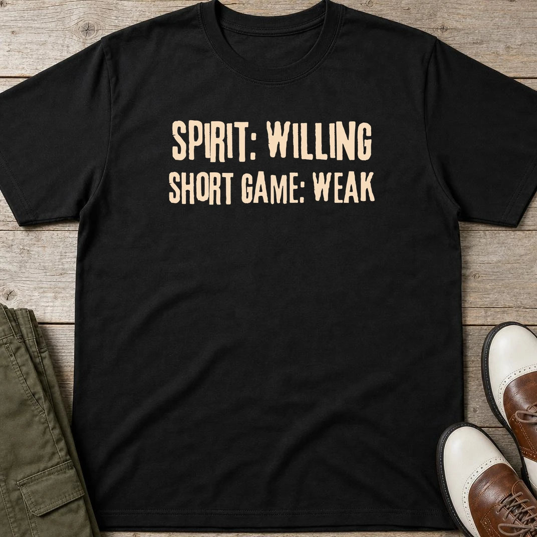 Spirit Willing T-Shirt in Black lying on a plain floor. T-shirt is a unisex cut and 100 per cent cotton.