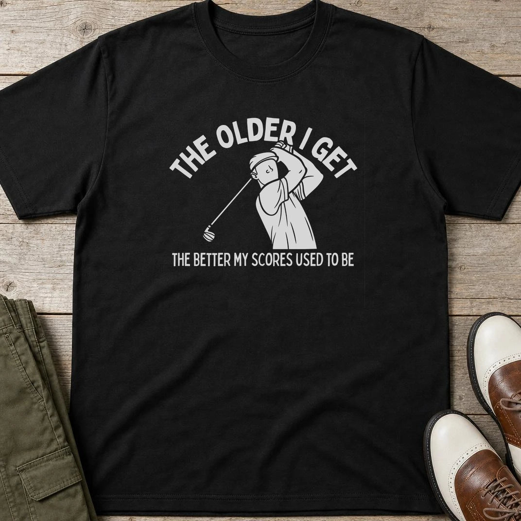 Older I Get T-Shirt in Black lying on a plain floor. T-shirt is a unisex cut and 100 per cent cotton.