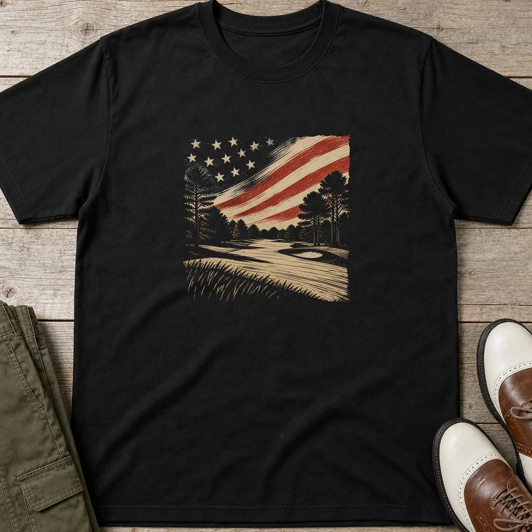US Golf Course T-Shirt in Black lying on a plain floor. T-shirt is a unisex cut and 100 per cent cotton.