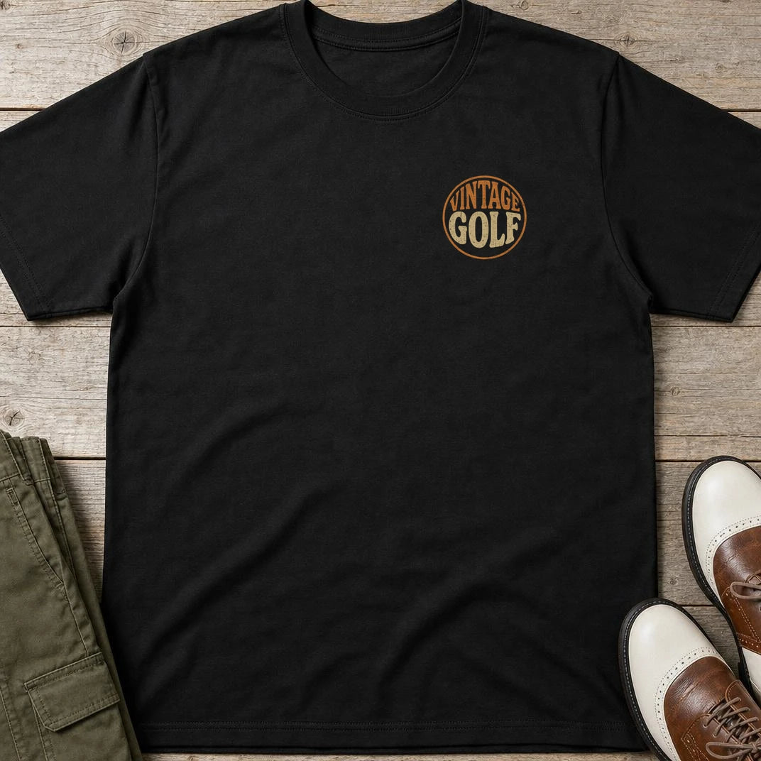 Vintage Golf Pocket T-Shirt in Black lying on a plain floor. T-shirt is a unisex cut and 100 per cent cotton.