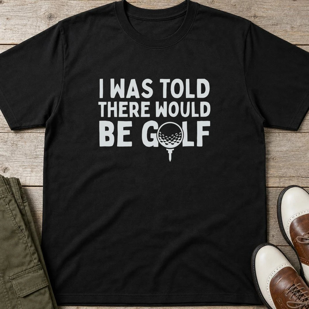I Was Told T-Shirt in Black lying on a plain floor. T-shirt is a unisex cut and 100 per cent cotton.