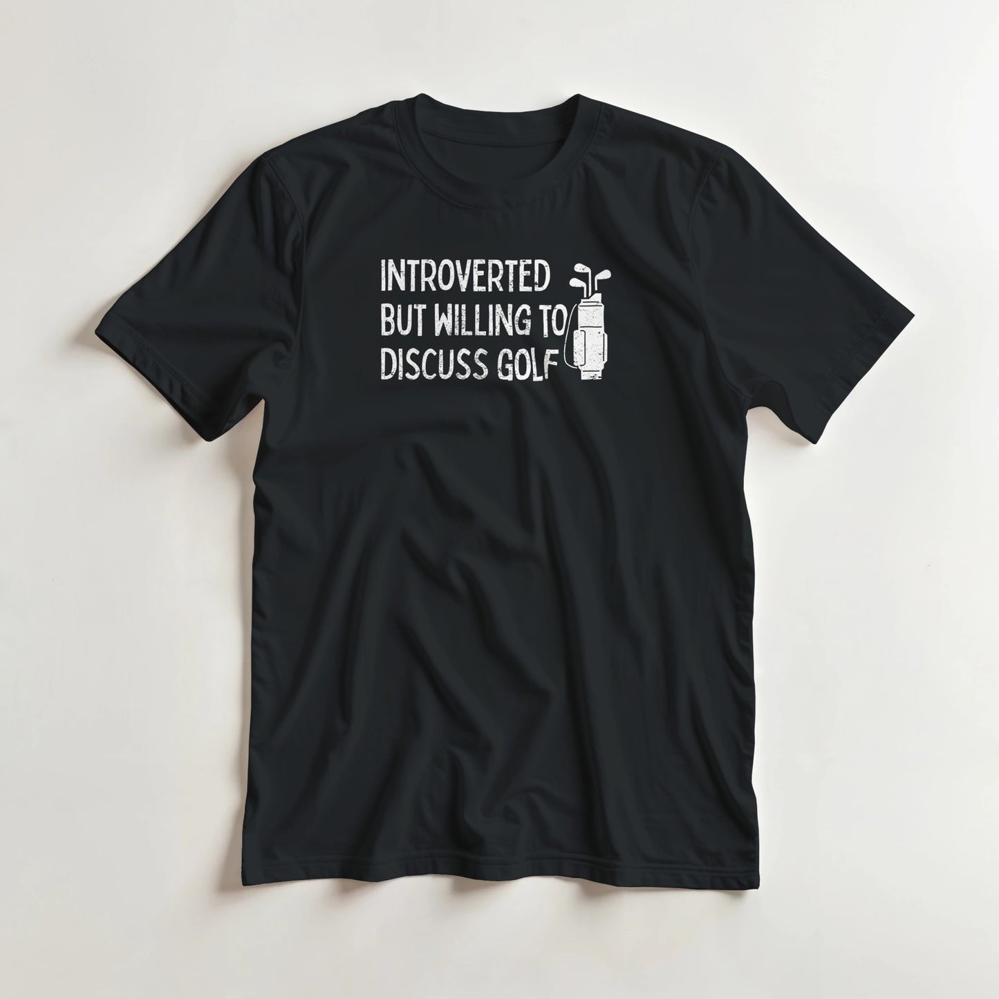 Introverted T-Shirt in Black lying on a plain floor. T-shirt is a unisex cut and 100 per cent cotton.