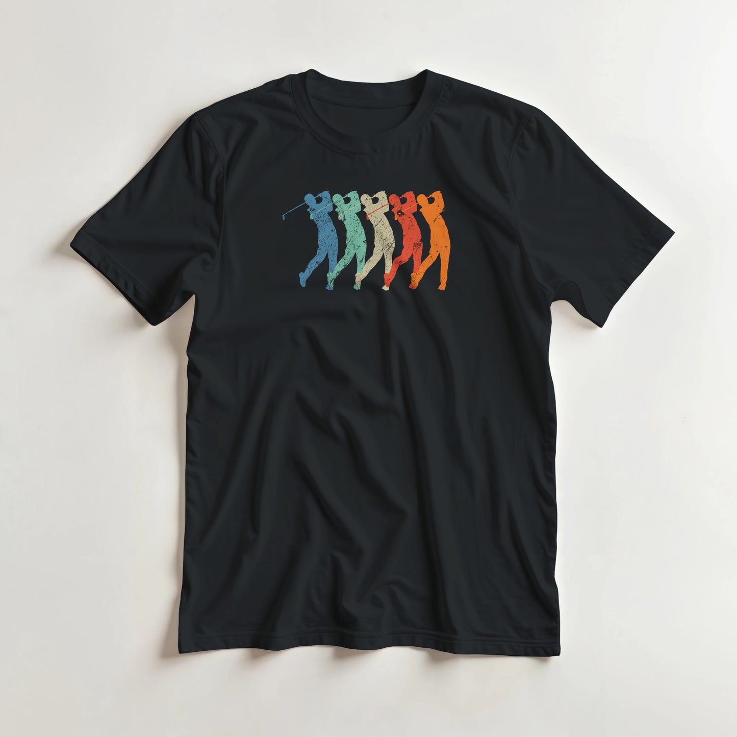 Golf Swing T-Shirt in Black lying on a plain floor. T-shirt is a unisex cut and 100 per cent cotton.